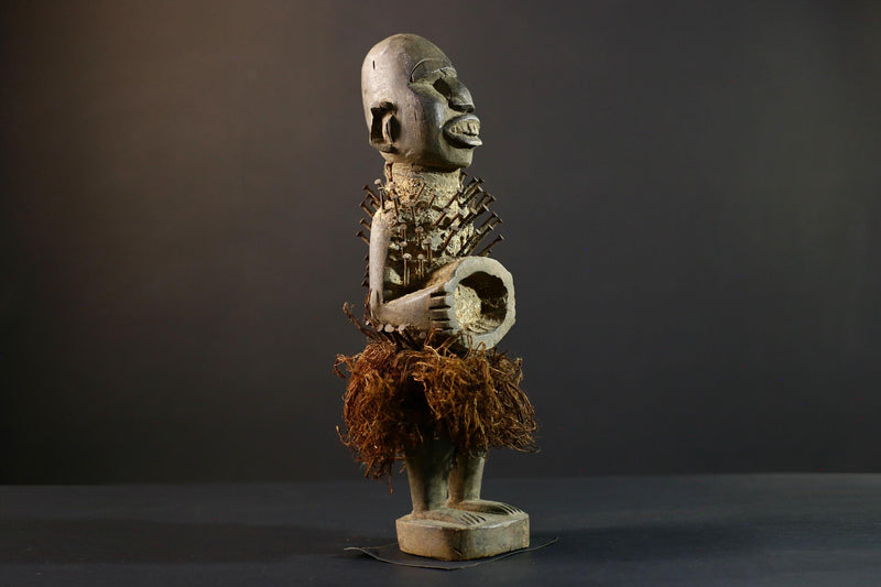 African Nkisi Nkondi nailed fetish statue Congo power figure tribal charm carved wood ritual art protective totem cavity raffia skirt-G5371