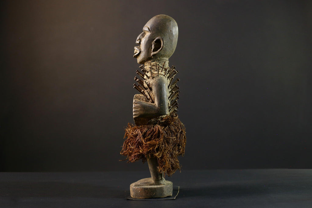African Nkisi Nkondi nailed fetish statue Congo power figure tribal charm carved wood ritual art protective totem cavity raffia skirt-G5371
