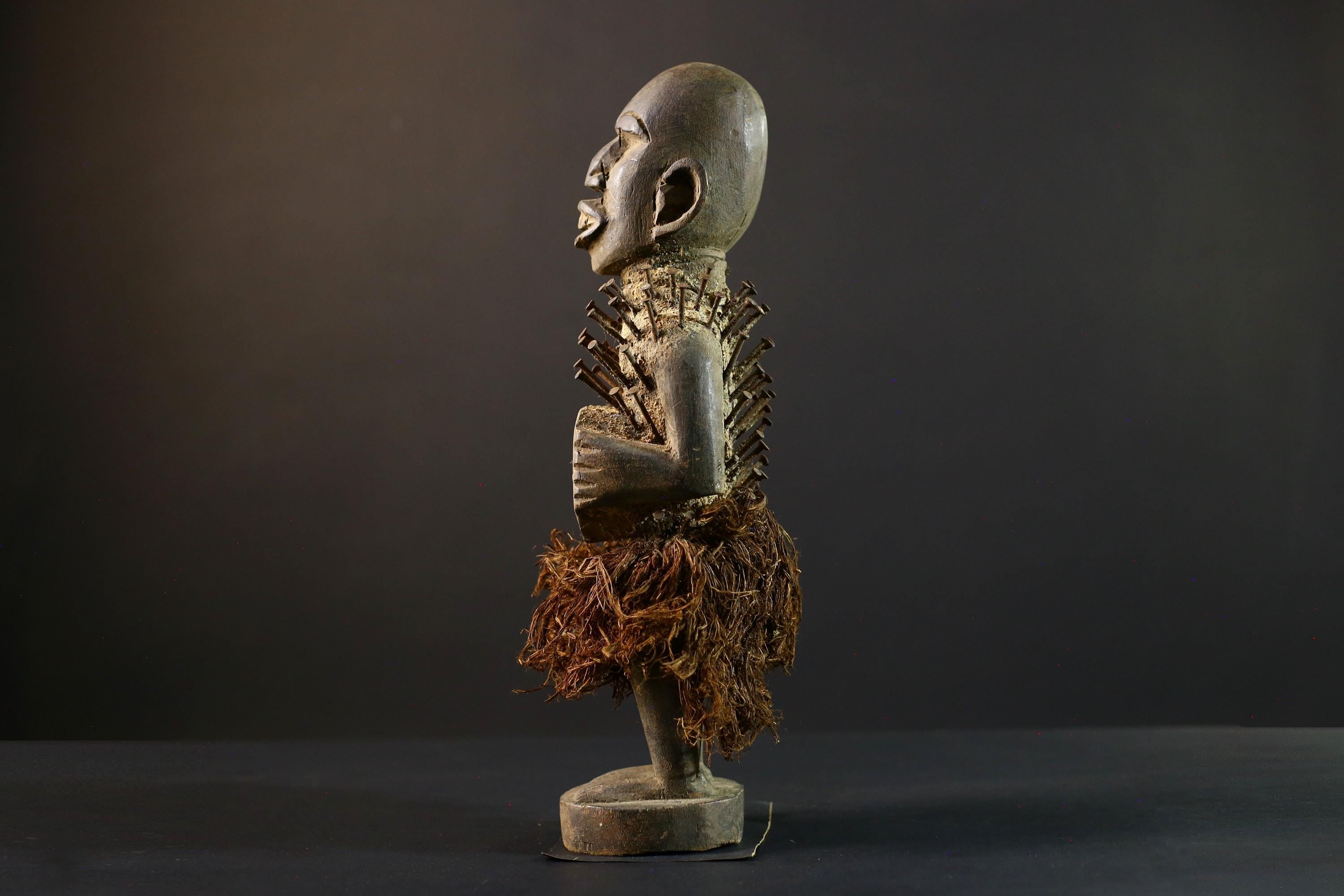 African Nkisi Nkondi nailed fetish statue Congo power figure tribal charm carved wood ritual art protective totem cavity raffia skirt-G5371