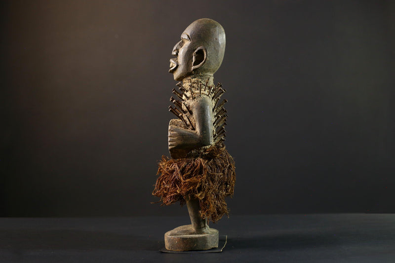 African Nkisi Nkondi nailed fetish statue Congo power figure tribal charm carved wood ritual art protective totem cavity raffia skirt-G5371