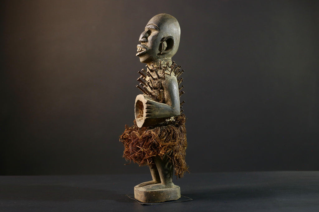 African Nkisi Nkondi nailed fetish statue Congo power figure tribal charm carved wood ritual art protective totem cavity raffia skirt-G5371