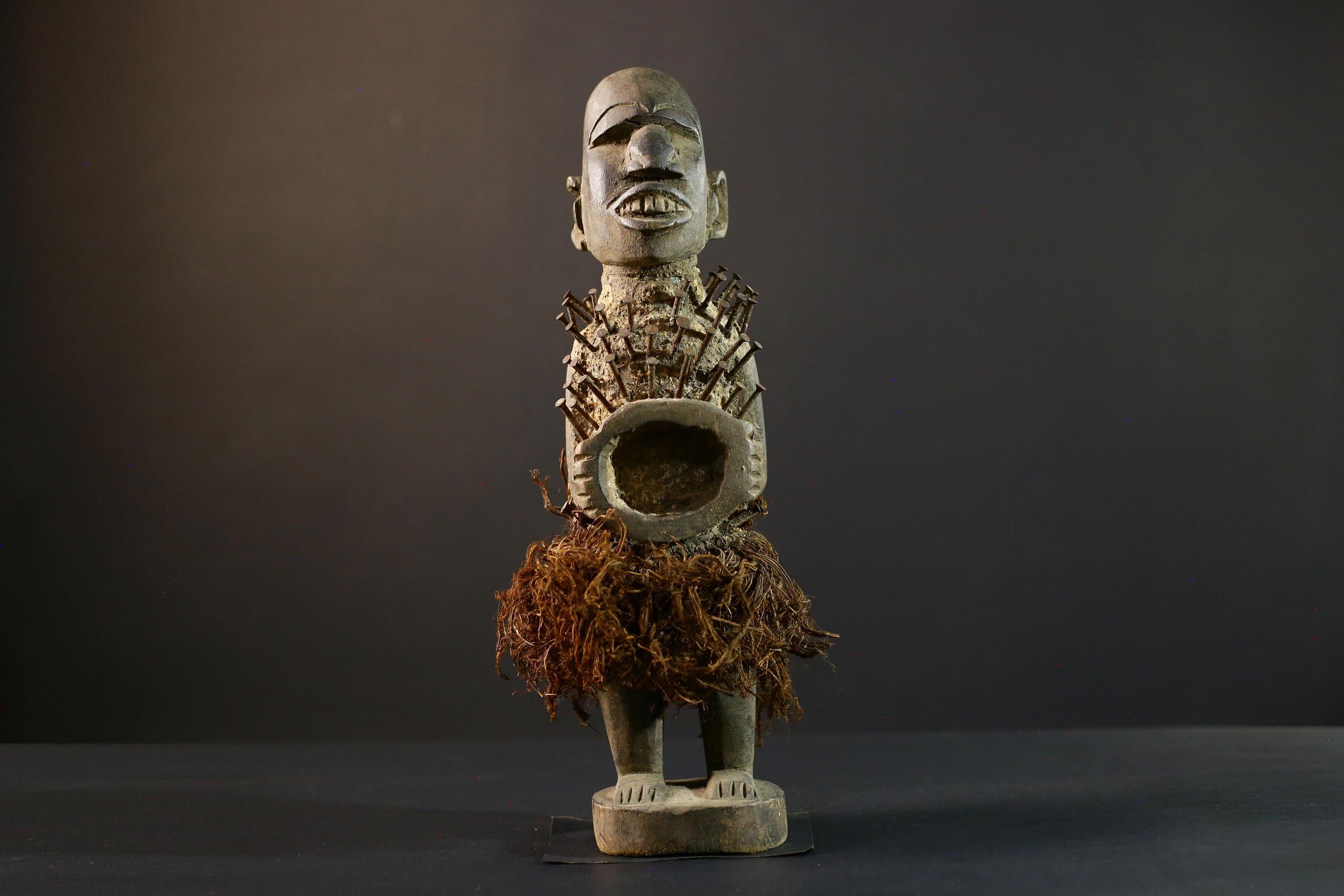African Nkisi Nkondi nailed fetish statue Congo power figure tribal charm carved wood ritual art protective totem cavity raffia skirt-G5371
