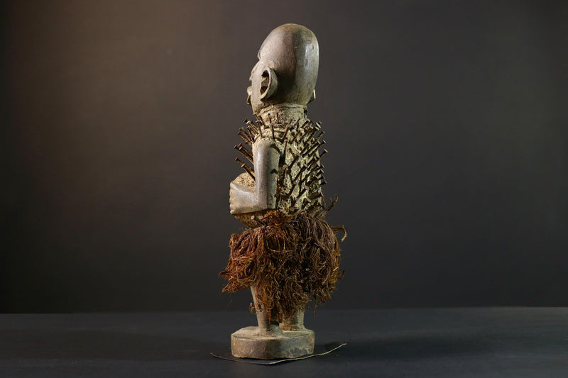 African Nkisi Nkondi nailed fetish statue Congo power figure tribal charm carved wood ritual art protective totem cavity raffia skirt-G5371