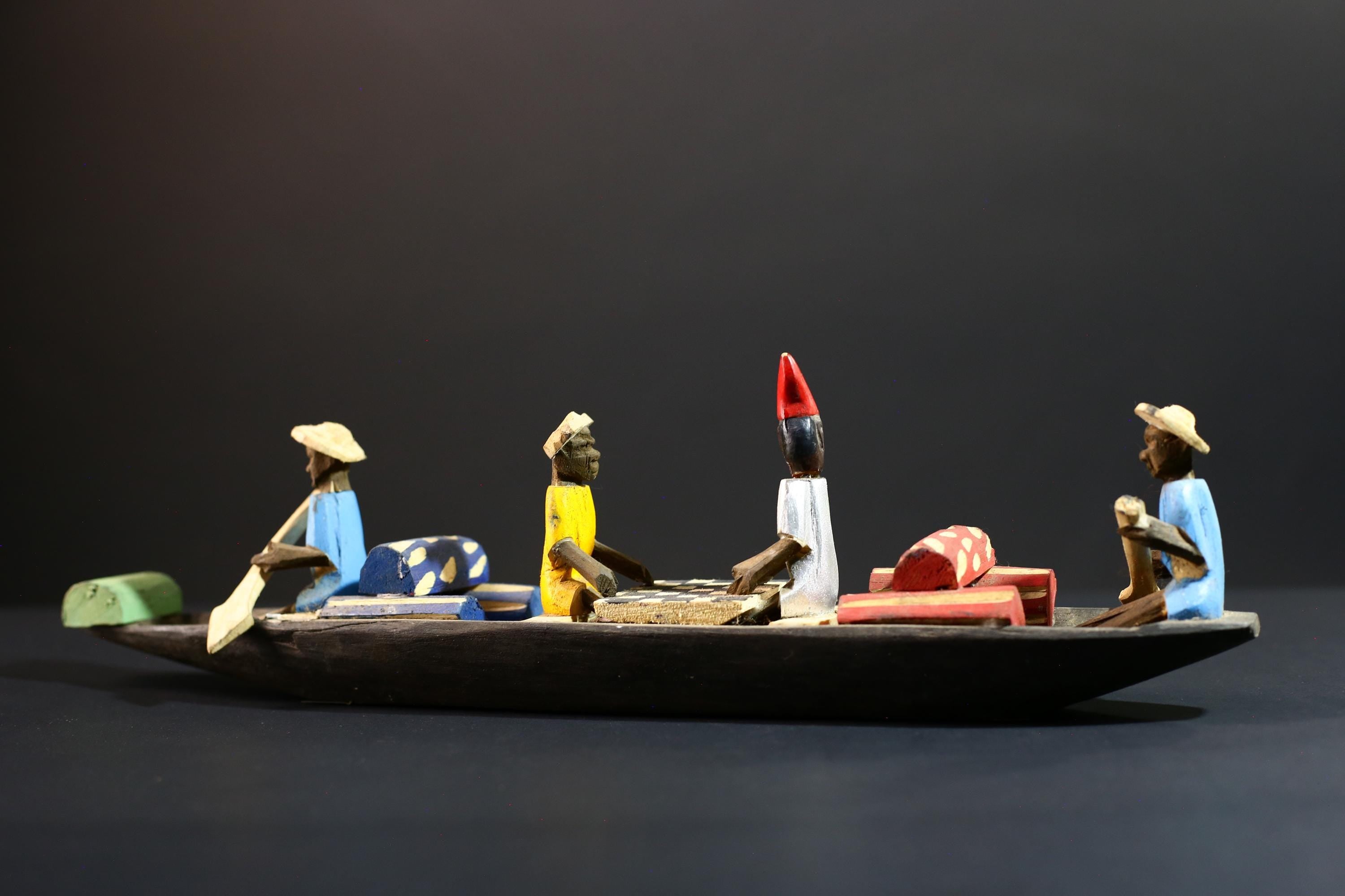 African canoe sculpture, river trade folk art decor, hand carved wooden boat, Congolese village scene, colorful African figures-G5405