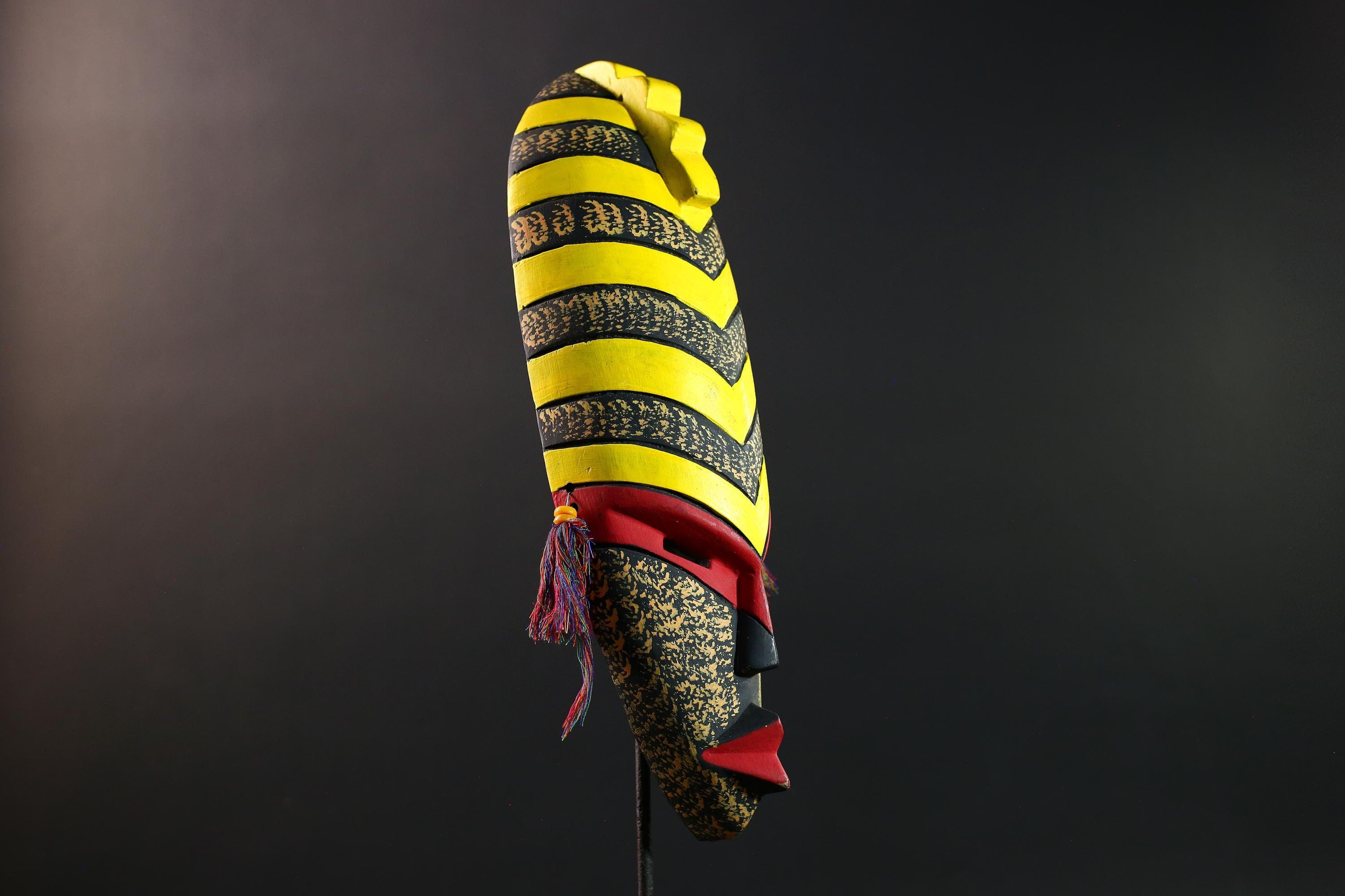 African tribal mask yellow black chevron face carving with red eyes and side tassels from Gabon or Congo handmade wall decor art- G5441