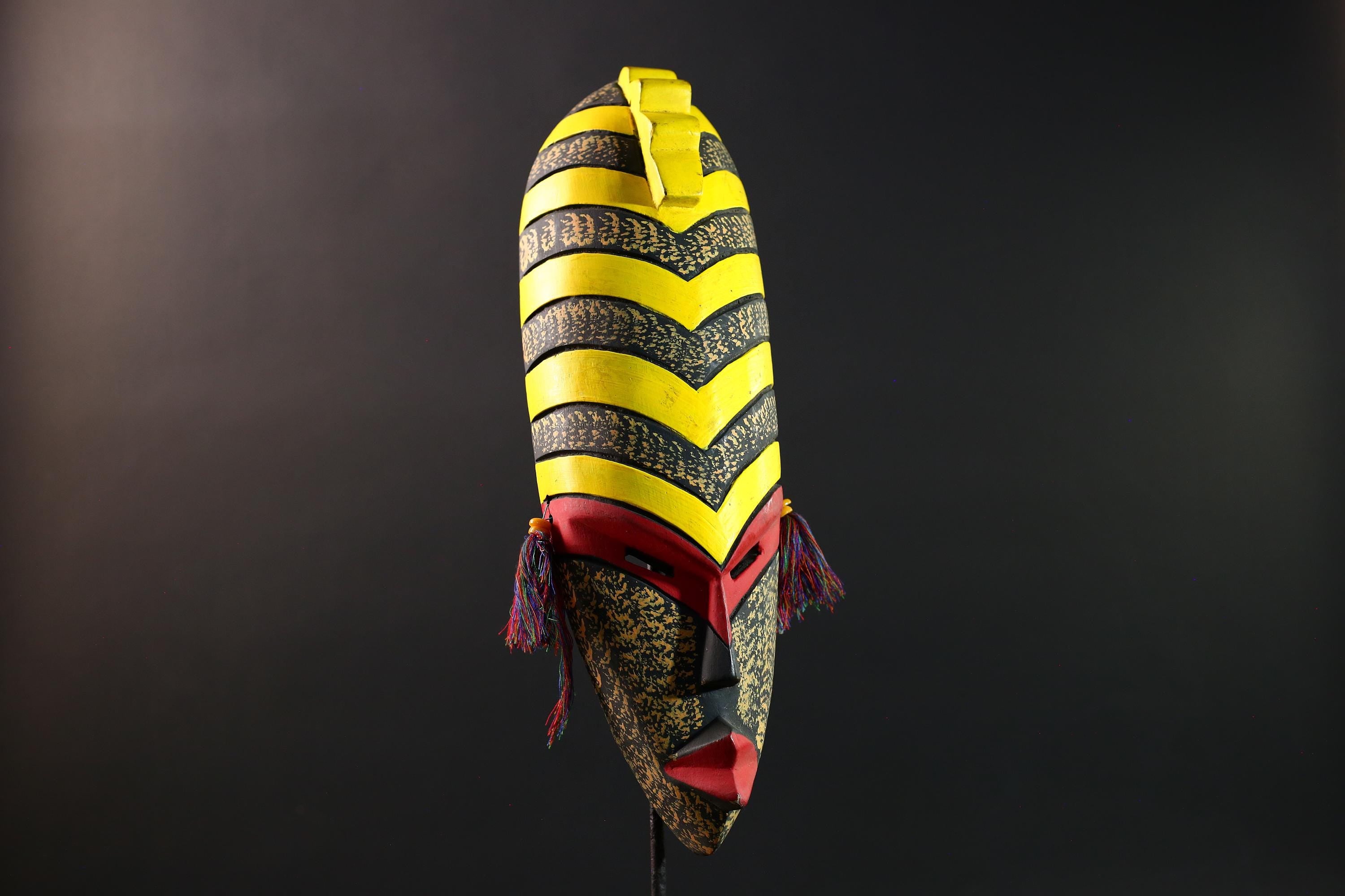 African tribal mask yellow black chevron face carving with red eyes and side tassels from Gabon or Congo handmade wall decor art- G5441