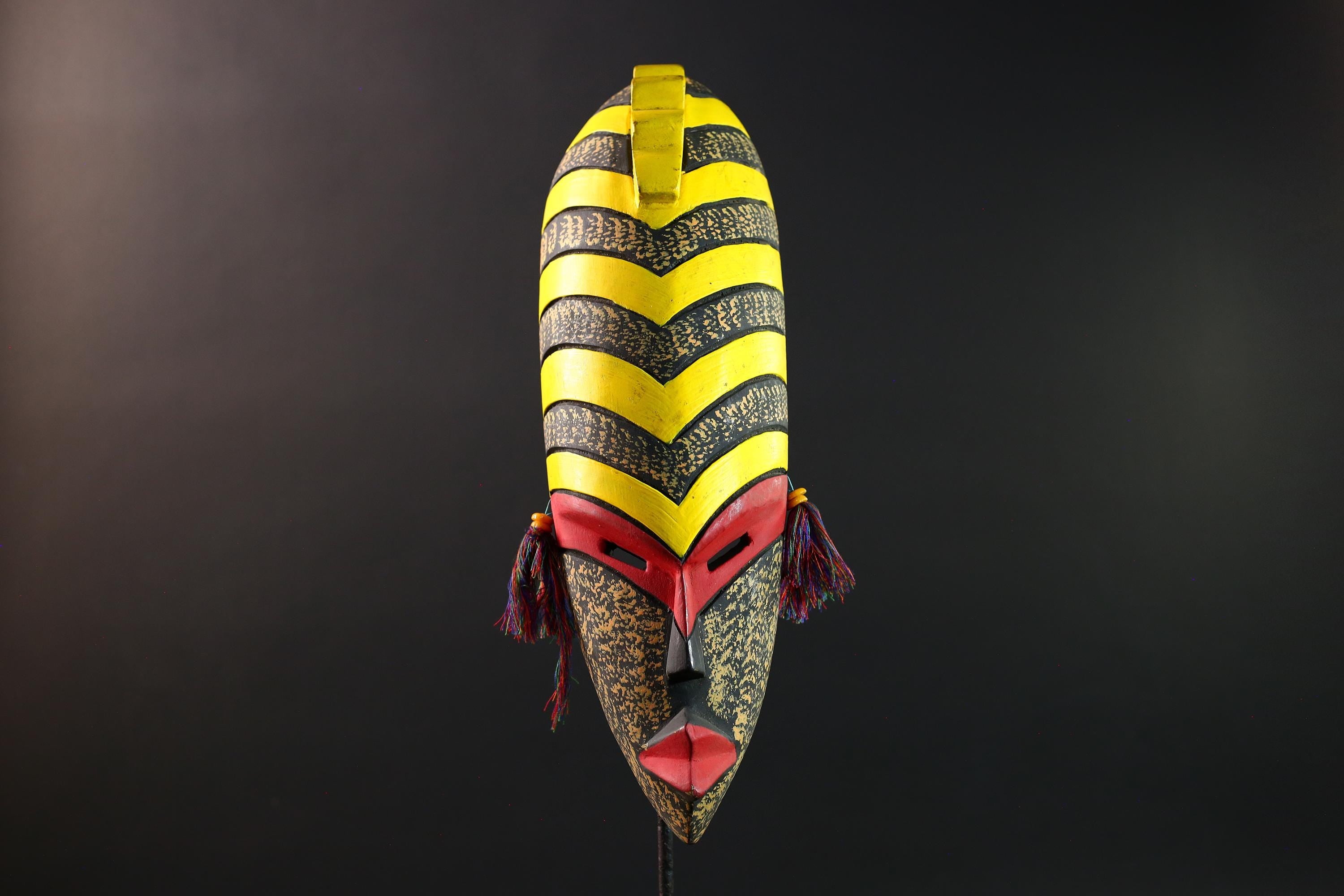 African tribal mask yellow black chevron face carving with red eyes and side tassels from Gabon or Congo handmade wall decor art- G5441