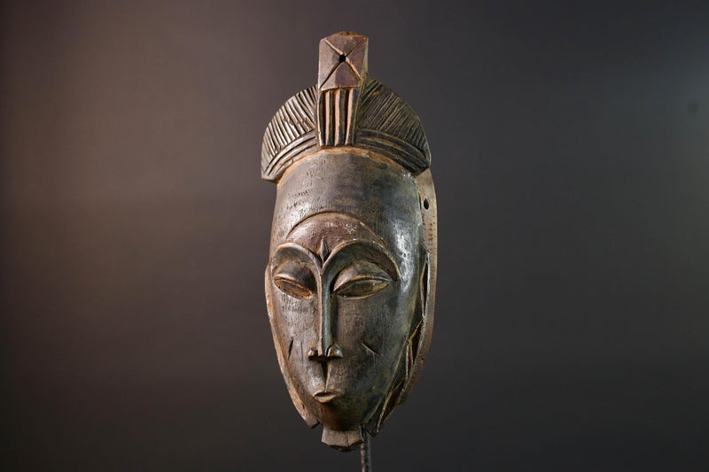 African wall decor Baule tribal mask with downcast eyes geometric accents and tall domed crest for symbolic interior statement piece G5498