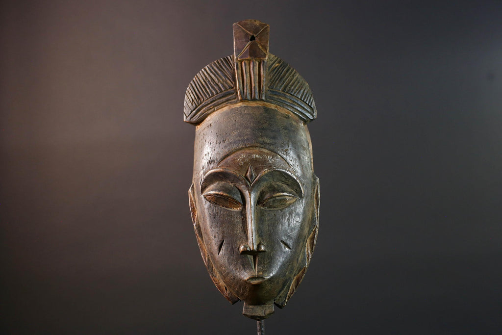 African wall decor Baule tribal mask with downcast eyes geometric accents and tall domed crest for symbolic interior statement piece G5498