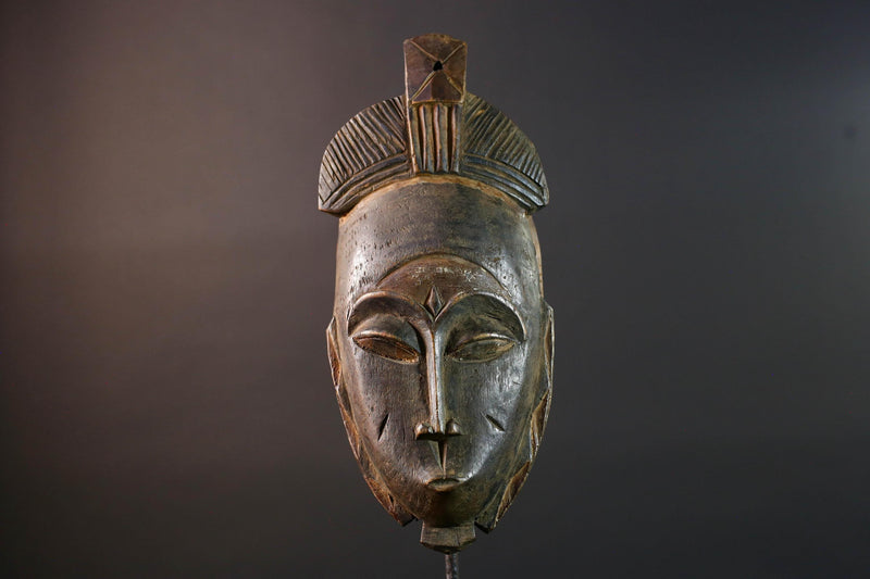 African wall decor Baule tribal mask with downcast eyes geometric accents and tall domed crest for symbolic interior statement piece G5498
