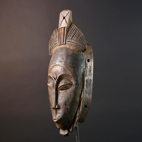 African wall decor Baule tribal mask with downcast eyes geometric accents and tall domed crest for symbolic interior statement piece G5498