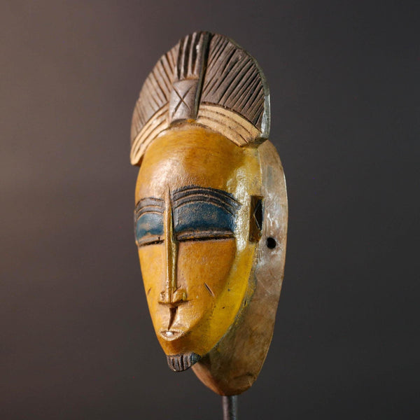 Baule tribal wall decor mask with yellow face blue brow ridged crest and scarified cheeks for african spiritual home interior design G5500