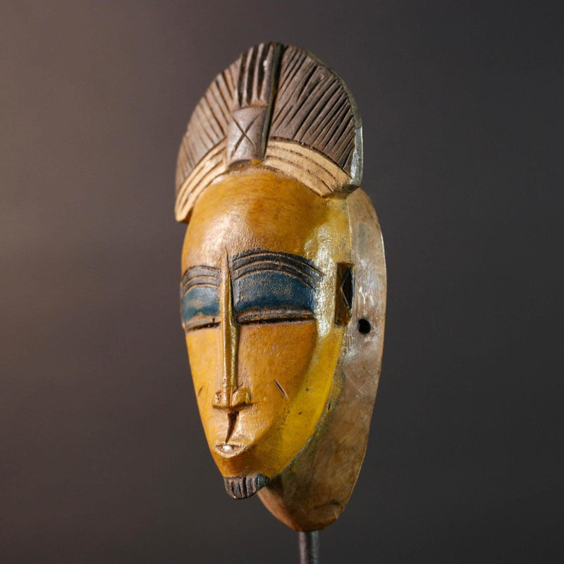 Baule tribal wall decor mask with yellow face blue brow ridged crest and scarified cheeks for african spiritual home interior design G5500