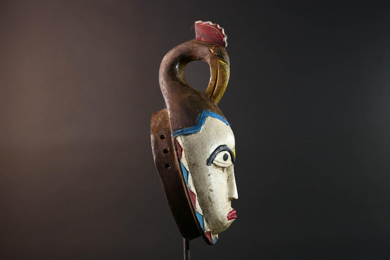 African tribal mask Guro carved wood wall decor with pale face red lips arched brow animal crest artisan symbolic ethnic sculpture-G5519