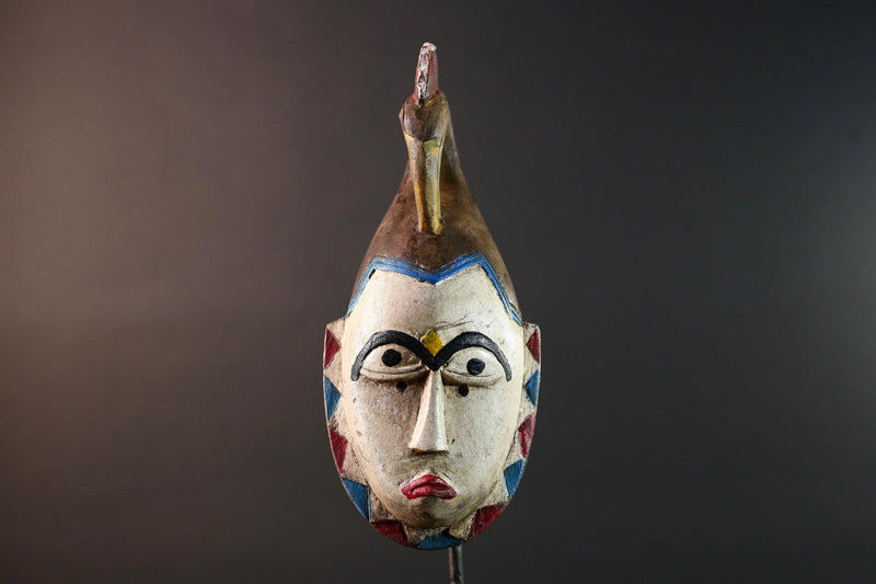 African tribal mask Guro carved wood wall decor with pale face red lips arched brow animal crest artisan symbolic ethnic sculpture-G5519