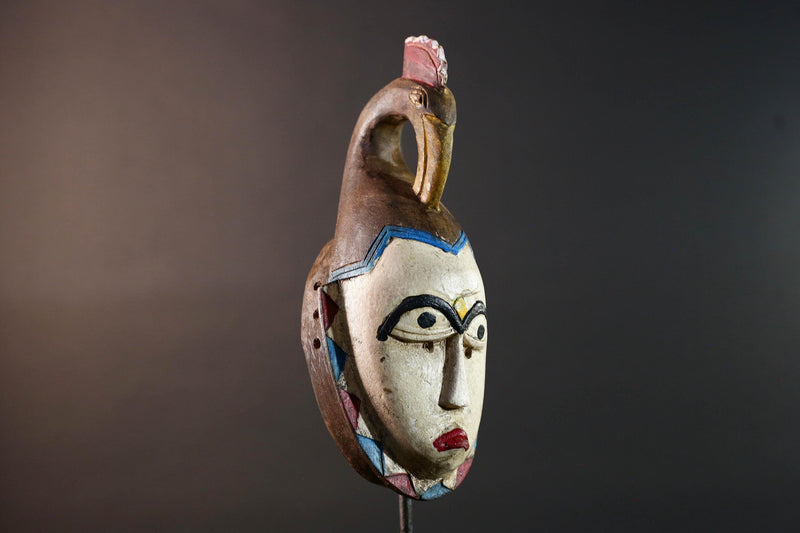 African tribal mask Guro carved wood wall decor with pale face red lips arched brow animal crest artisan symbolic ethnic sculpture-G5519
