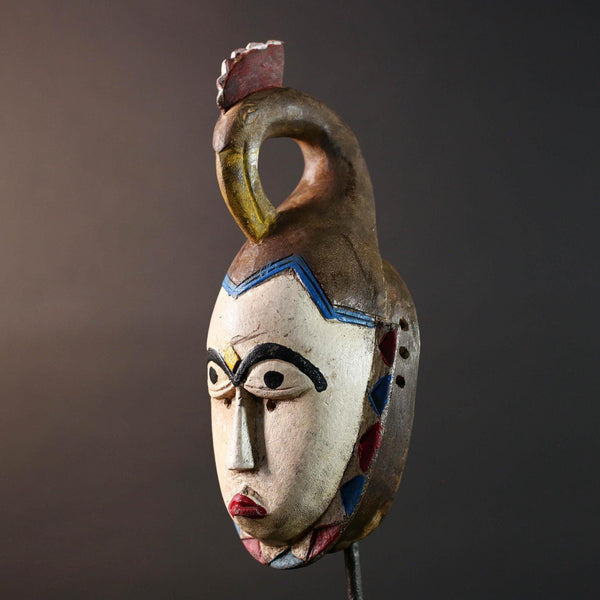 African tribal mask Guro carved wood wall decor with pale face red lips arched brow animal crest artisan symbolic ethnic sculpture-G5519