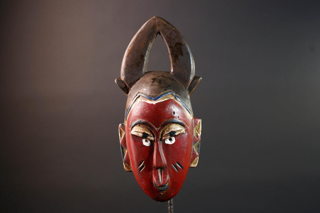 African tribal mask Guro carved wood wall decor with red face double horn crest stylized eyes artisan figure symbolic ethnic art-G5518
