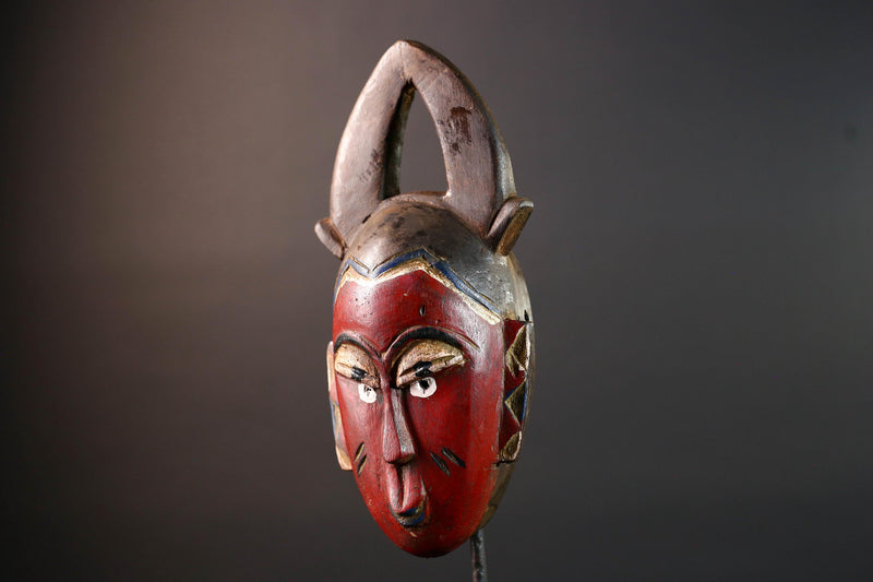 African tribal mask Guro carved wood wall decor with red face double horn crest stylized eyes artisan figure symbolic ethnic art-G5518