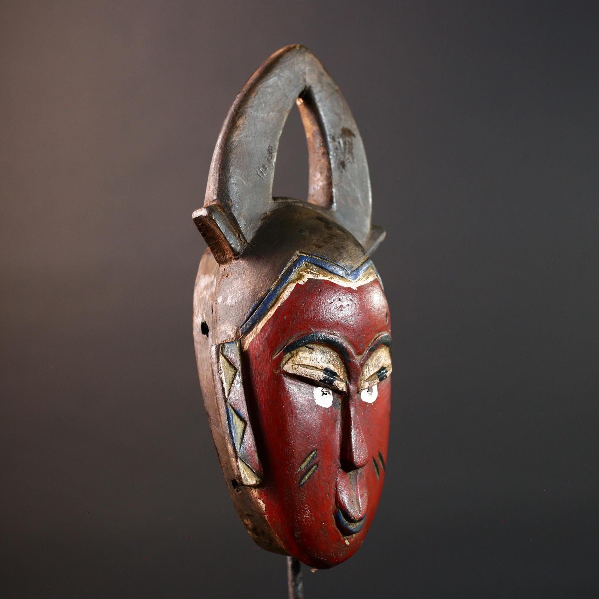 African tribal mask Guro carved wood wall decor with red face double horn crest stylized eyes artisan figure symbolic ethnic art-G5518