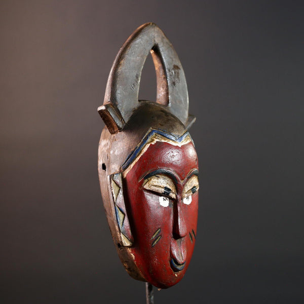 African tribal mask Guro carved wood wall decor with red face double horn crest stylized eyes artisan figure symbolic ethnic art-G5518
