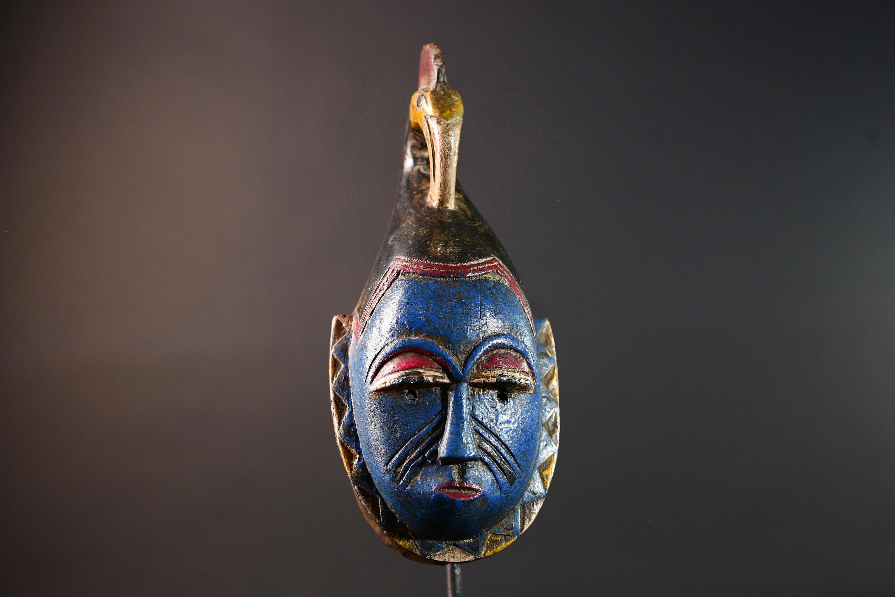 African tribal mask Guro carved wood wall decor with blue face bird crest scarification red white eyelids artisan symbolic sculpture-G5517