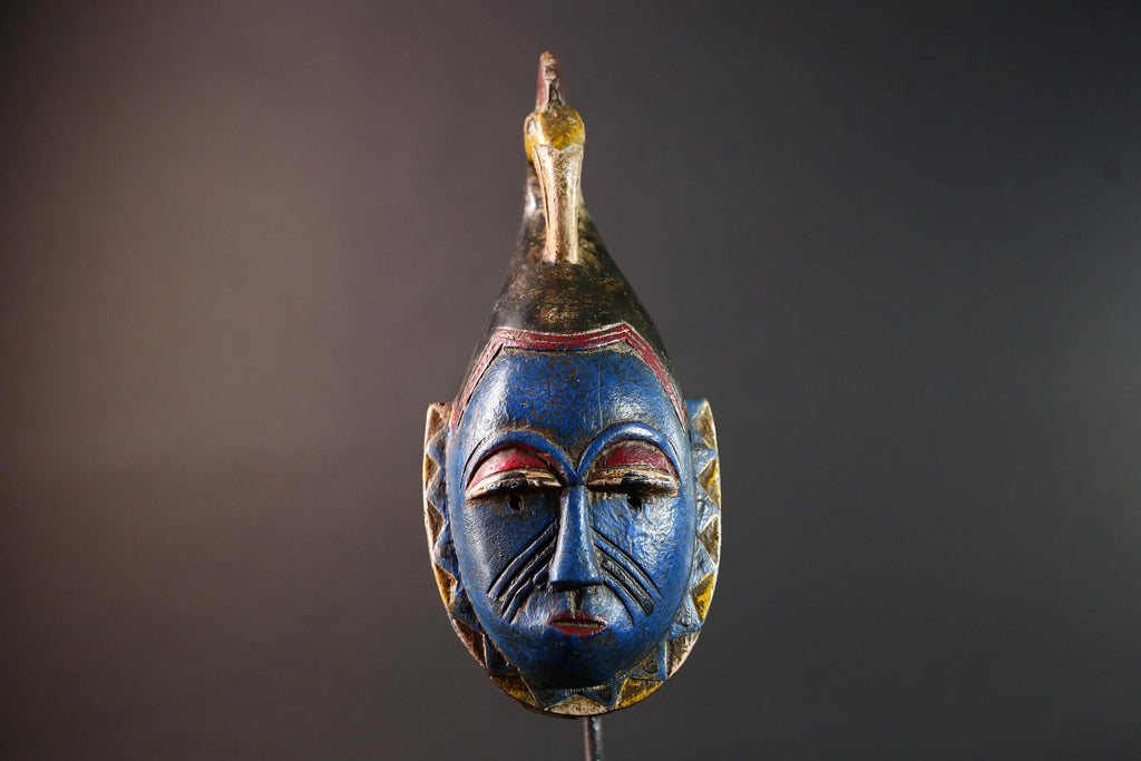 African tribal mask Guro carved wood wall decor with blue face bird crest scarification red white eyelids artisan symbolic sculpture-G5517