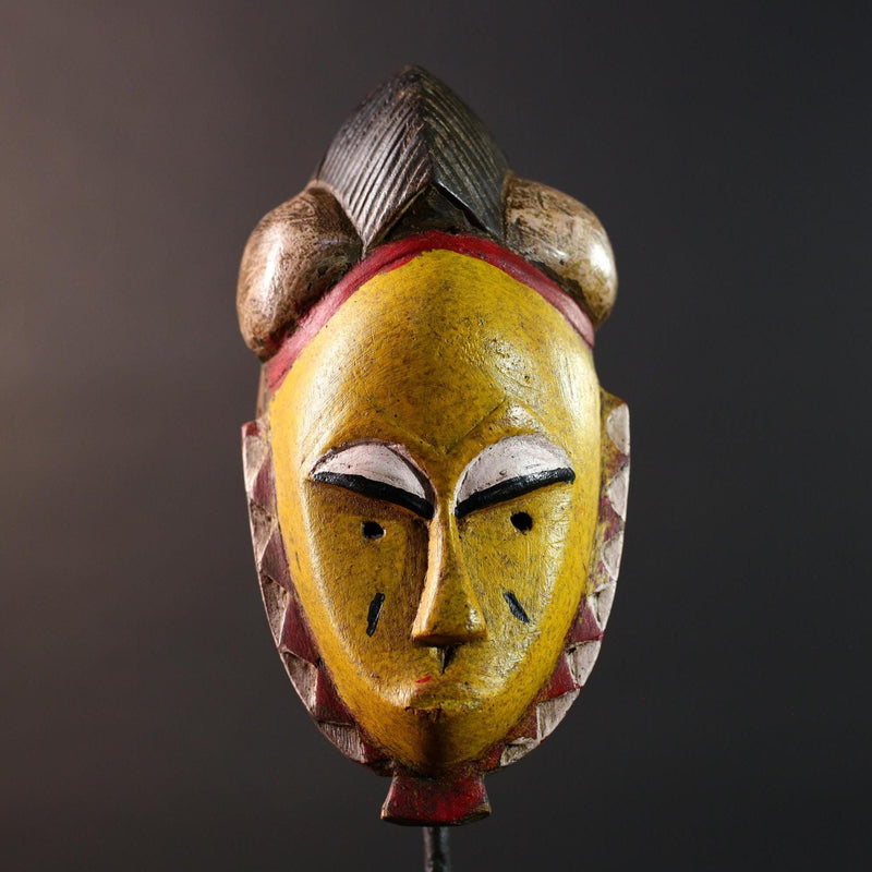 African mask Baule tribe yellow face carved wood with almond eyes rounded side buns geometric cheeks and central crest wall decor-G5539