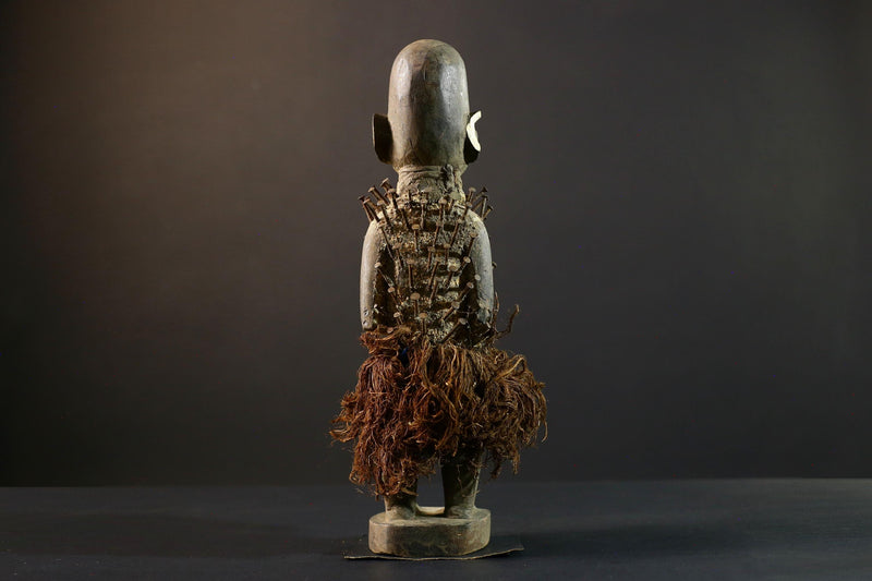 African Nkisi Nkondi nailed fetish statue Congo power figure tribal charm carved wood ritual art protective totem cavity raffia skirt-G5371