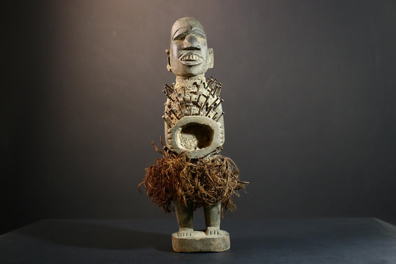 African Nkisi Nkondi nailed fetish statue Congo power figure tribal charm carved wood ritual art protective totem cavity raffia skirt-G5371