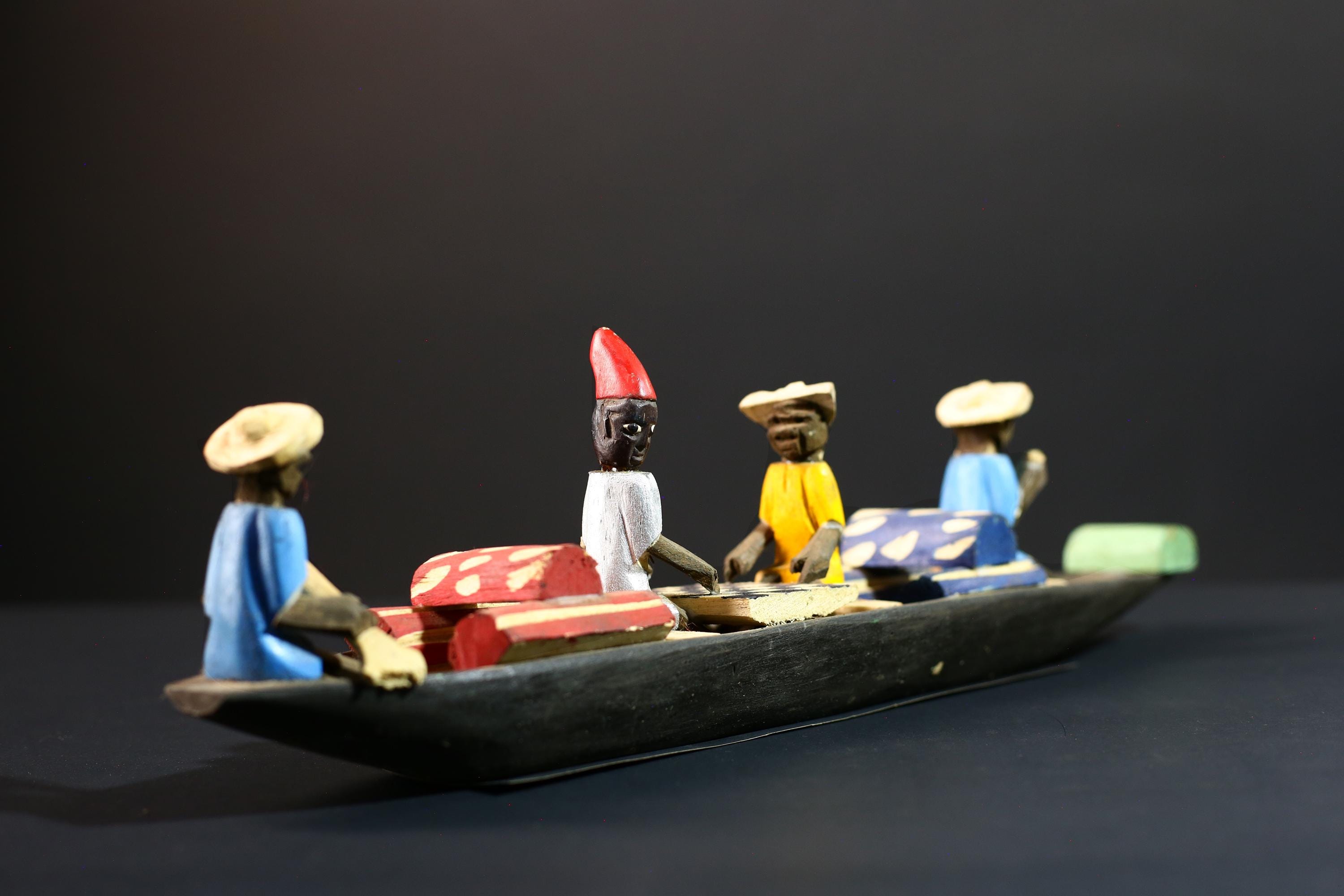 African canoe sculpture, river trade folk art decor, hand carved wooden boat, Congolese village scene, colorful African figures-G5405