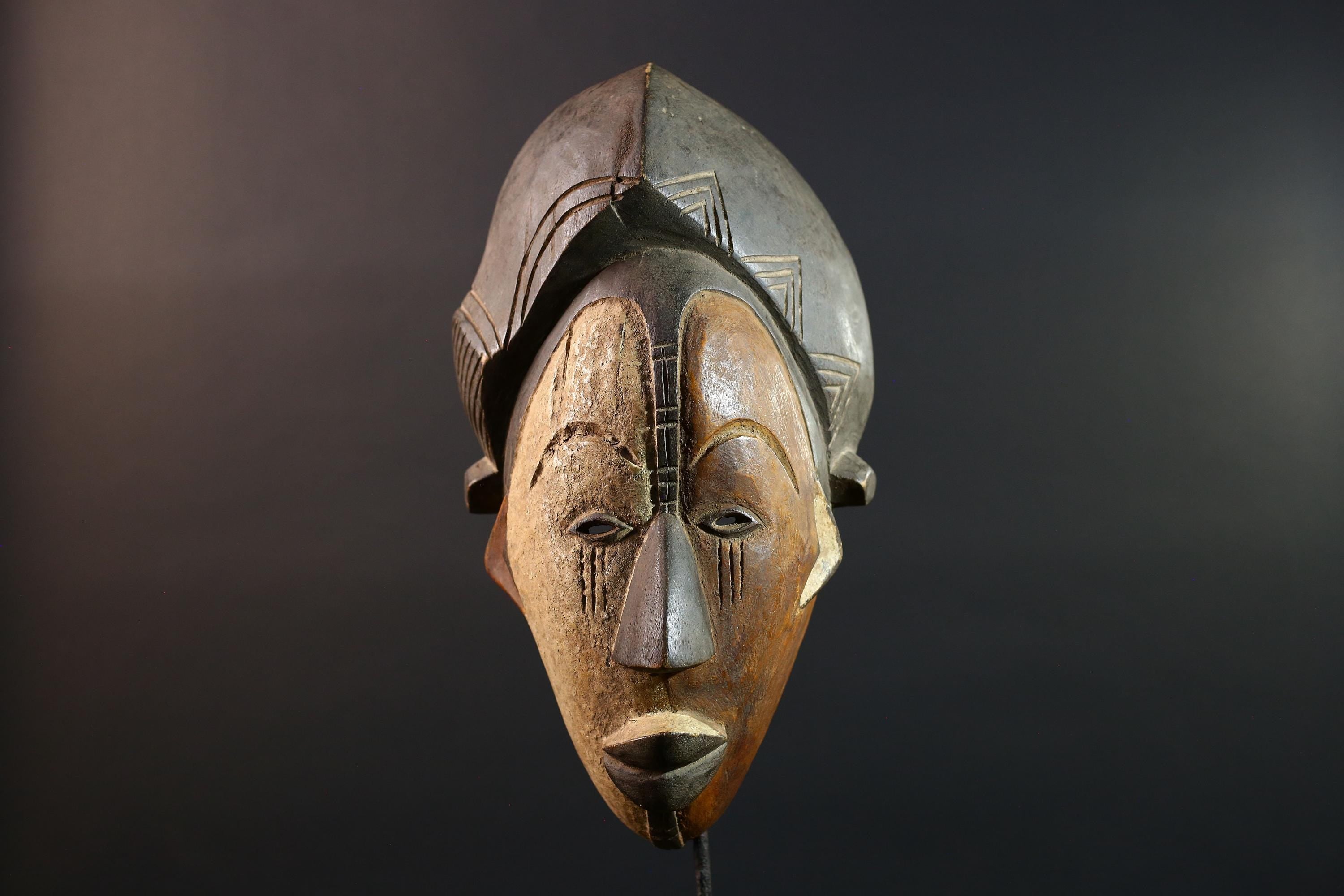 Hand carved African Punu mask tribal wall decor with kaolin white face and tall braided crest art from Central Africa G5569