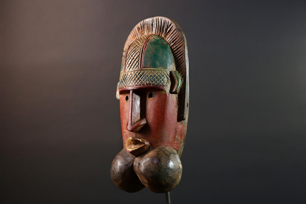 African mask Songye tribal decor with carved geometric features, red angular face, and bold cheek shapes wall hanging sculpture G5572