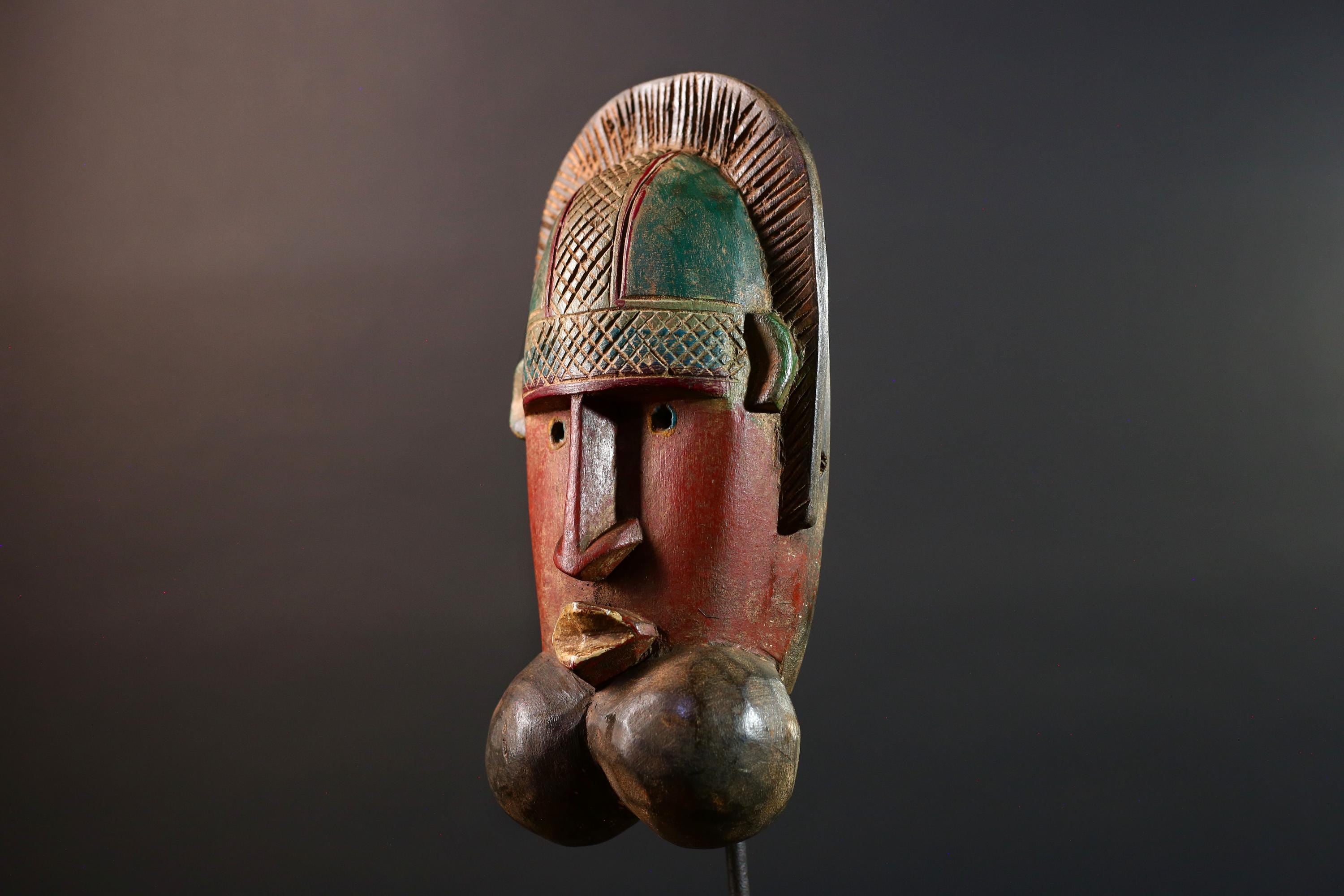 African mask Songye tribal decor with carved geometric features, red angular face, and bold cheek shapes wall hanging sculpture G5572