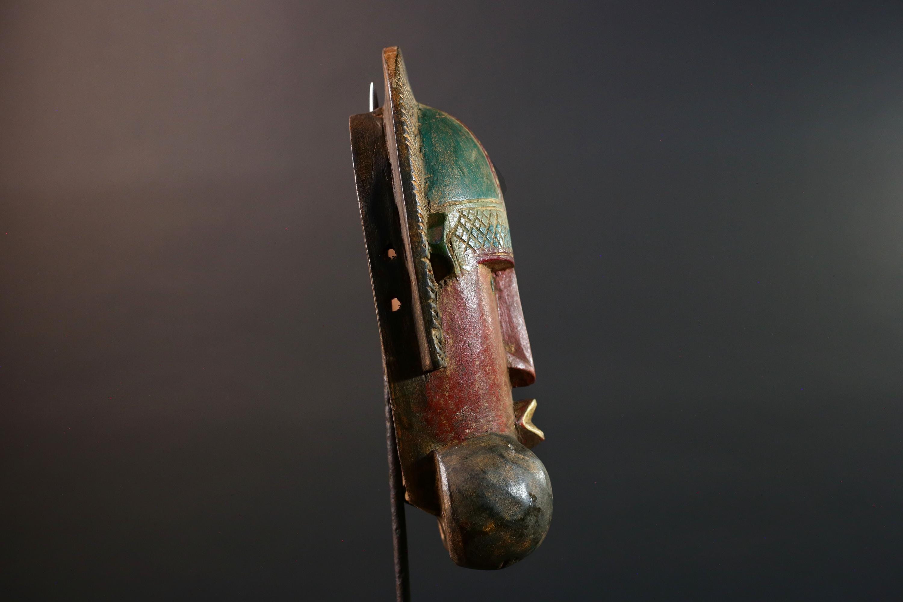 African mask Songye tribal decor with carved geometric features, red angular face, and bold cheek shapes wall hanging sculpture G5572