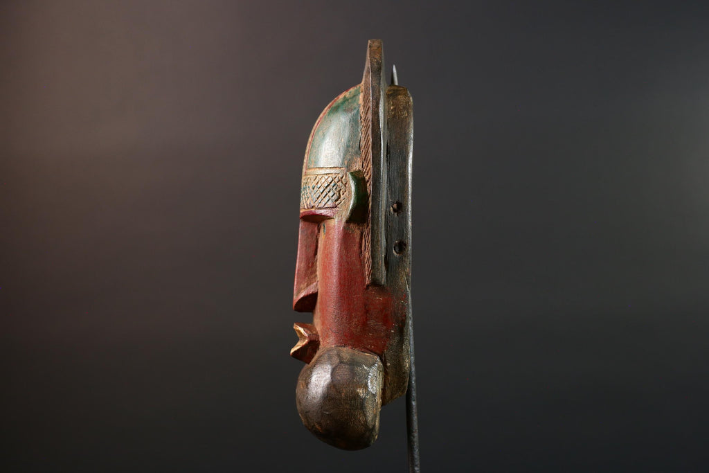 African mask Songye tribal decor with carved geometric features, red angular face, and bold cheek shapes wall hanging sculpture G5572
