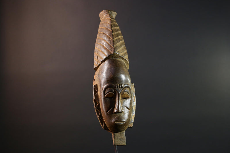 African mask Baule tribal art with long oval face, downcast eyes, vertical ridged crest, and carved cheek marks wall decor sculpture G5573