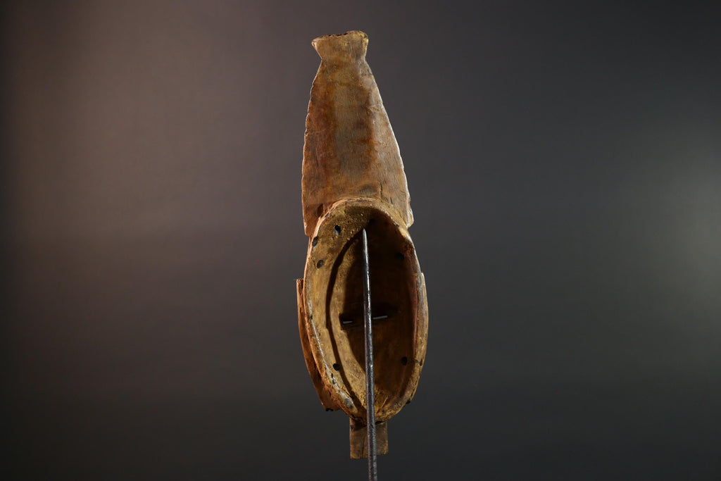 African mask Baule tribal art with long oval face, downcast eyes, vertical ridged crest, and carved cheek marks wall decor sculpture G5573