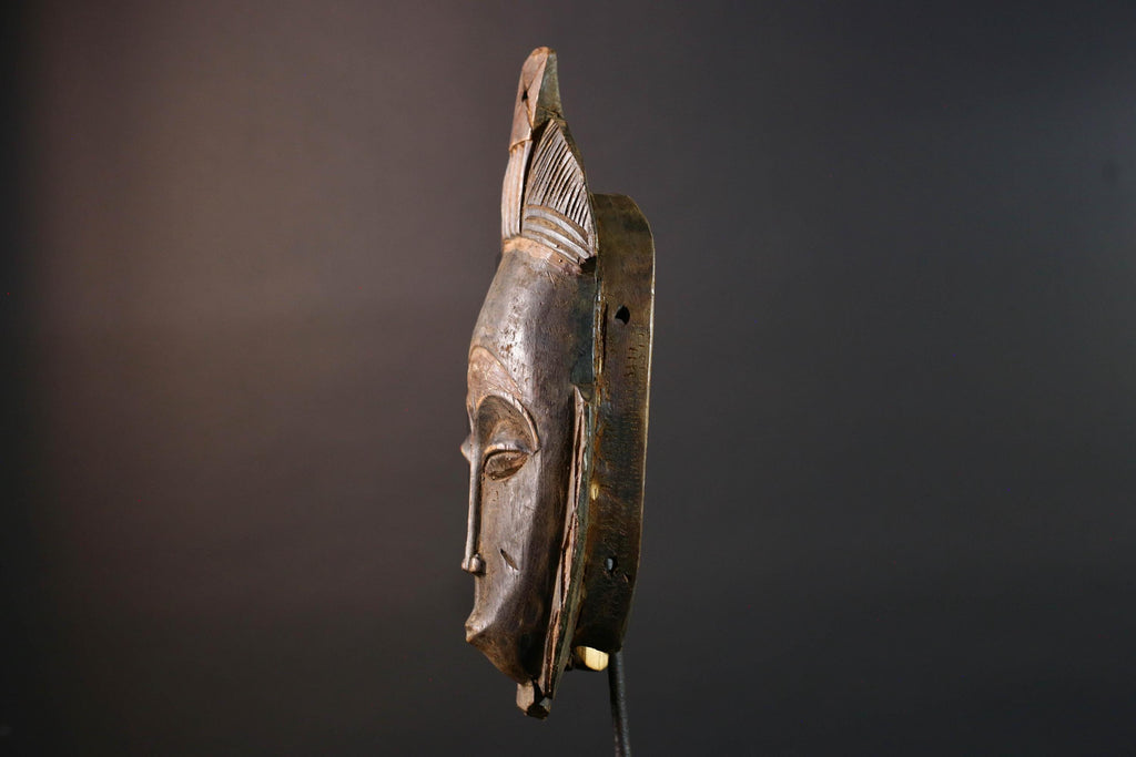 African wall decor Baule tribal mask with downcast eyes geometric accents and tall domed crest for symbolic interior statement piece G5498