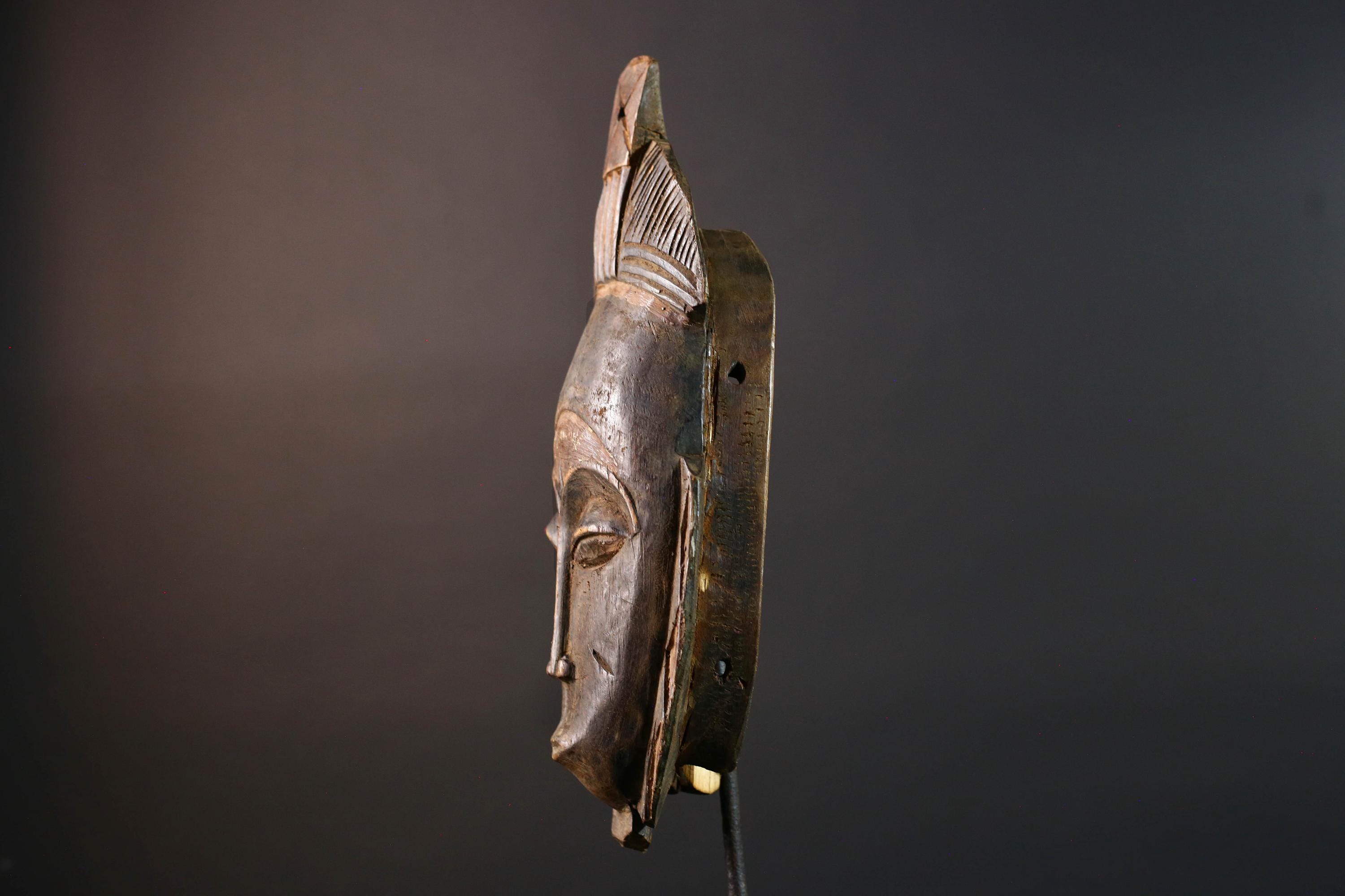 African wall decor Baule tribal mask with downcast eyes geometric accents and tall domed crest for symbolic interior statement piece G5498