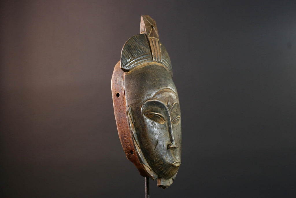 African wall decor Baule tribal mask with downcast eyes geometric accents and tall domed crest for symbolic interior statement piece G5498