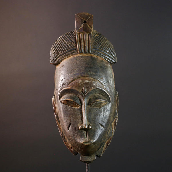 African wall decor Baule tribal mask with downcast eyes geometric accents and tall domed crest for symbolic interior statement piece G5498