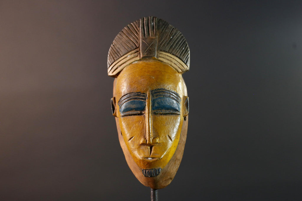 Baule tribal wall decor mask with yellow face blue brow ridged crest and scarified cheeks for african spiritual home interior design G5500
