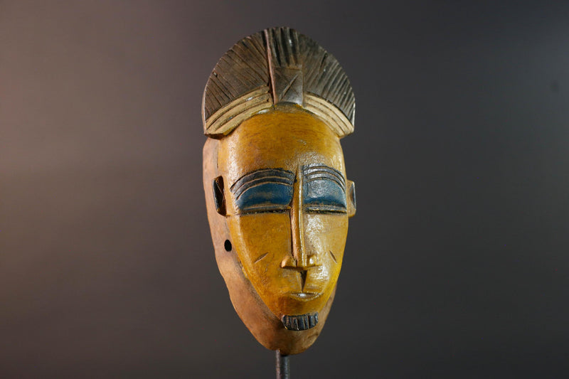 Baule tribal wall decor mask with yellow face blue brow ridged crest and scarified cheeks for african spiritual home interior design G5500