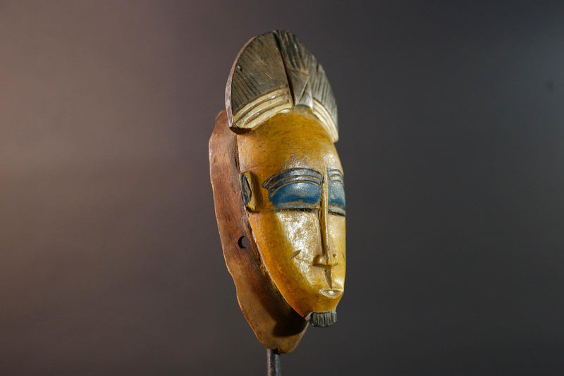 Baule tribal wall decor mask with yellow face blue brow ridged crest and scarified cheeks for african spiritual home interior design G5500