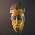 Baule tribal wall decor mask with yellow face blue brow ridged crest and scarified cheeks for african spiritual home interior design G5500