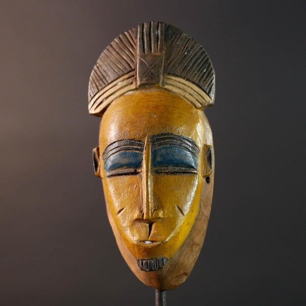 Baule tribal wall decor mask with yellow face blue brow ridged crest and scarified cheeks for african spiritual home interior design G5500