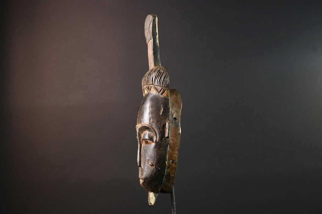 Africa tribal wall mask Baule carving with tall ridged crest narrow face and symbolic cheek marks for spiritual interior statement art G5502