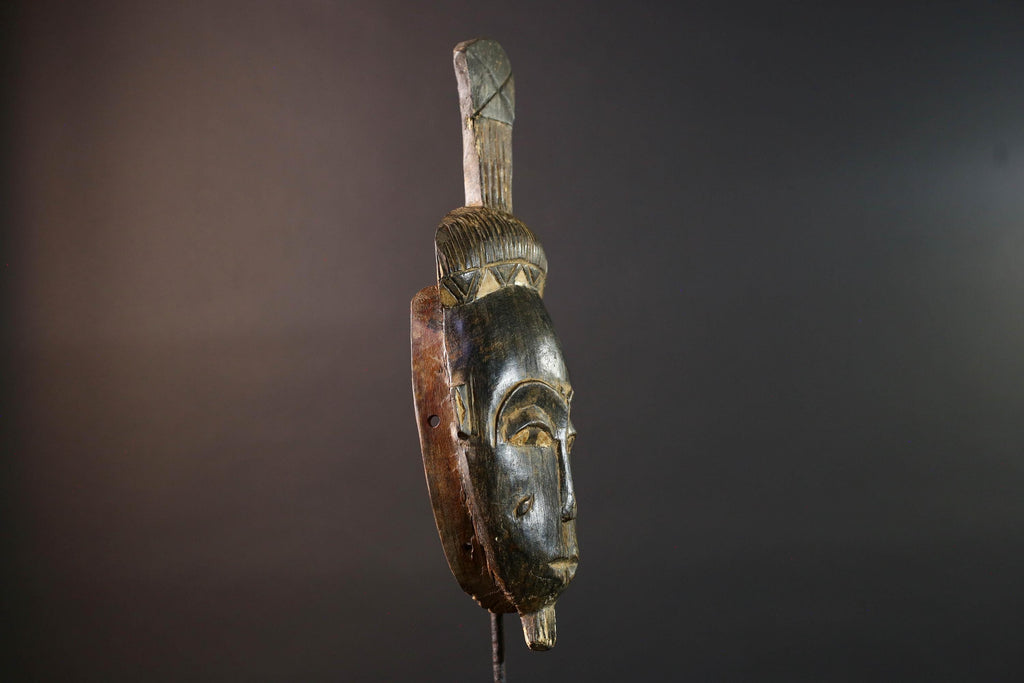 Africa tribal wall mask Baule carving with tall ridged crest narrow face and symbolic cheek marks for spiritual interior statement art G5502