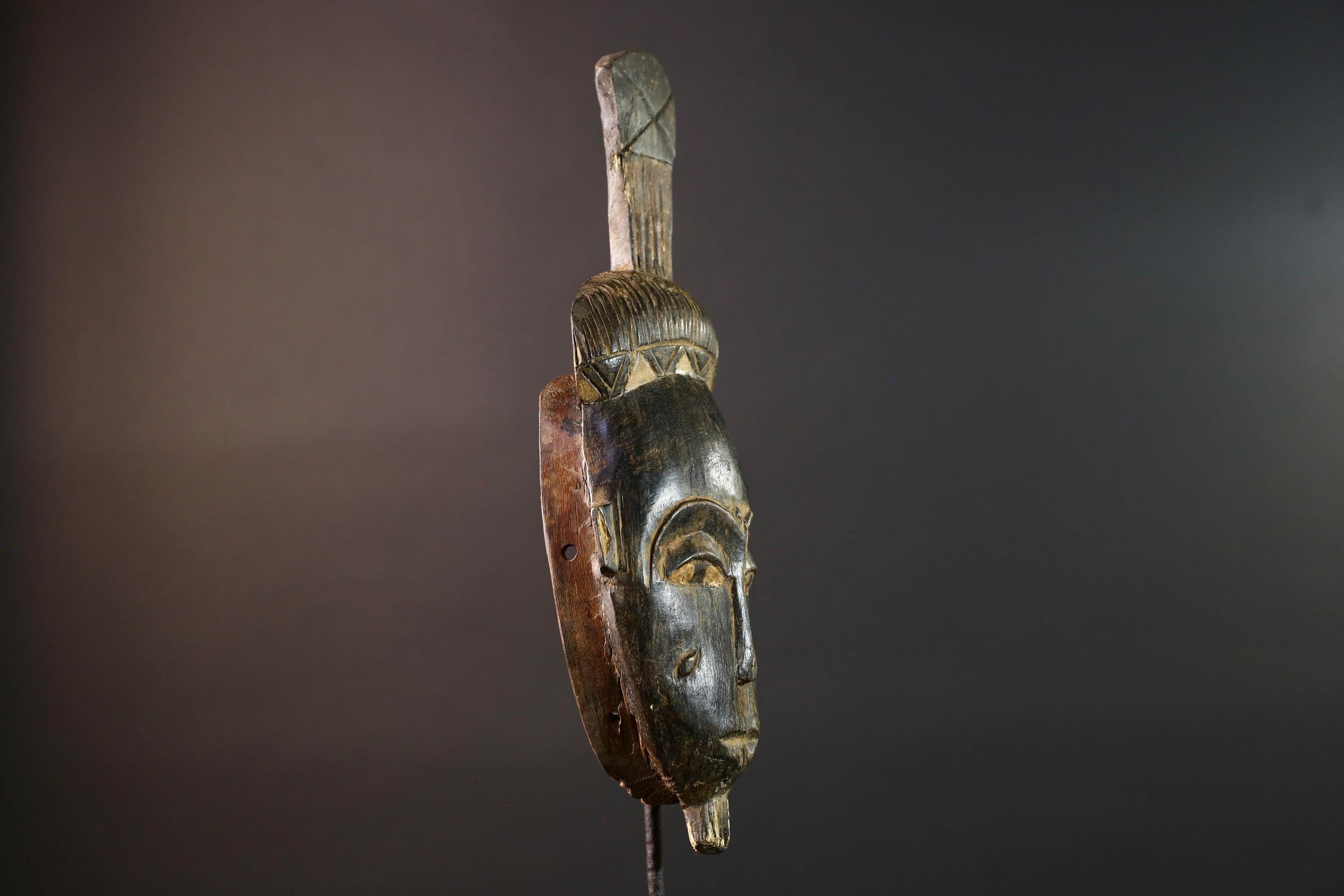 Africa tribal wall mask Baule carving with tall ridged crest narrow face and symbolic cheek marks for spiritual interior statement art G5502